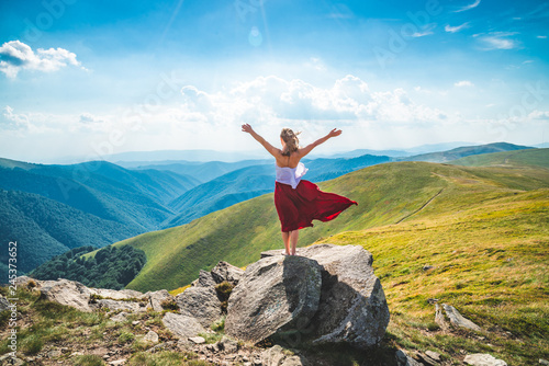 Young woman on the top of mountain