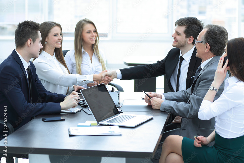 business partners shaking hands after a successful transaction business partners shaking hands after a successful transaction