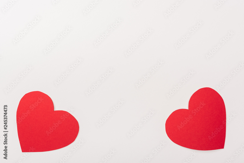 top view of red heart shaped paper cards isolated on white with copy space, st valentines day concept