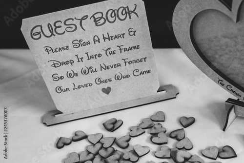 фотографія A wedding guest book with wooden love hearts