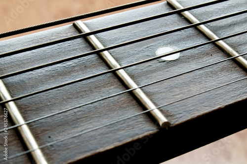 Fragment of an acoustic guitar - closeup shot