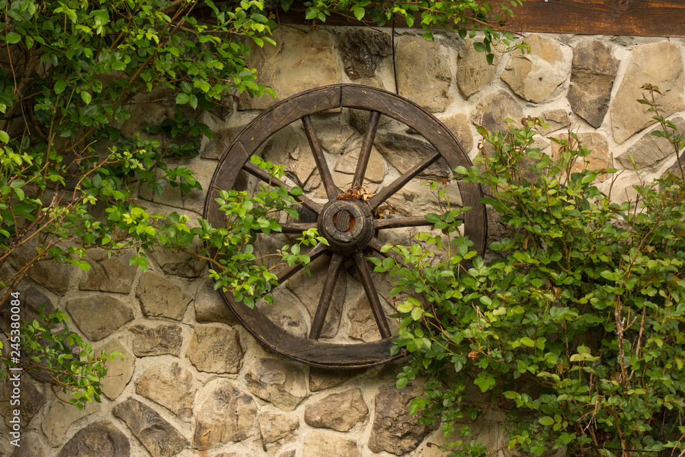 Old wooden wheel on the wall