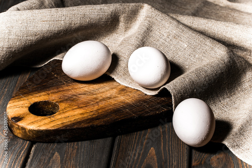White Easter Eggs and Rustic Kitchen with Wooden Cutting Board