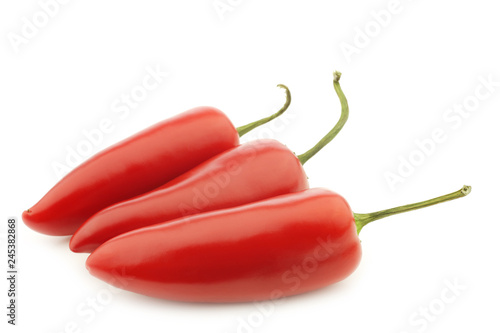 three red jalapeno peppers on a white background