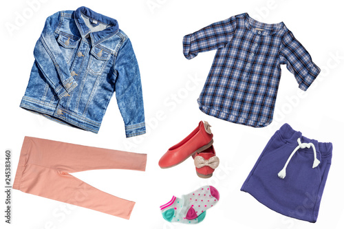 Top view on child girl set of clothes. Collage of apparel clothing. Skirts, sneaker, jeans, jacket, trousers and shirt isolated on a white background. Summer fashion.