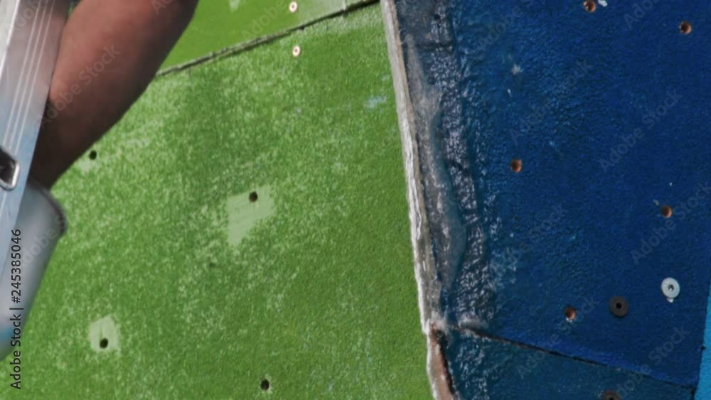 Man working on the construction of a climbing wall. Climbing wall in the process of being assembled Man working on the construction of a climbing wall. Climbing wall in the process of being assembled