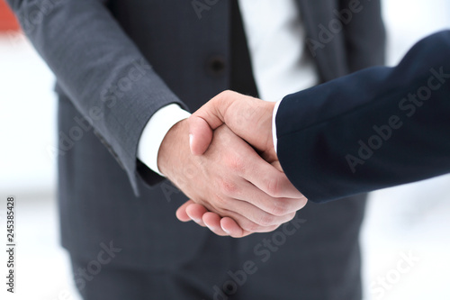 close up of two young male business partner shake hand