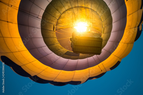 Down view on hot air balloon flying at night photo