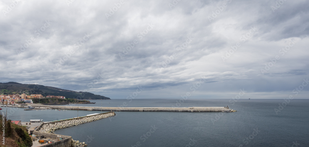 Breakwater of the fishing port of Bermeo on a cloudy day