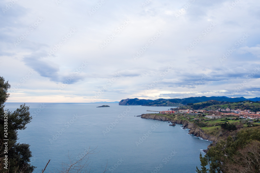 Fototapeta premium View of the coast of the village of Bermeo on a cloudy day, in the Basque Country