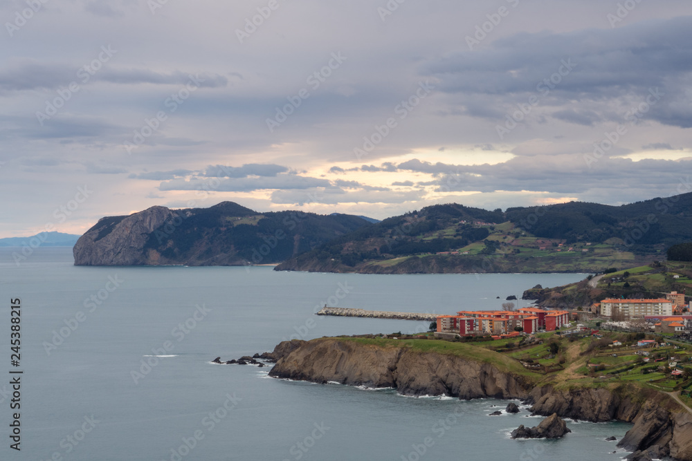 View of the coast of the village of Bermeo on a cloudy day, in the Basque Country