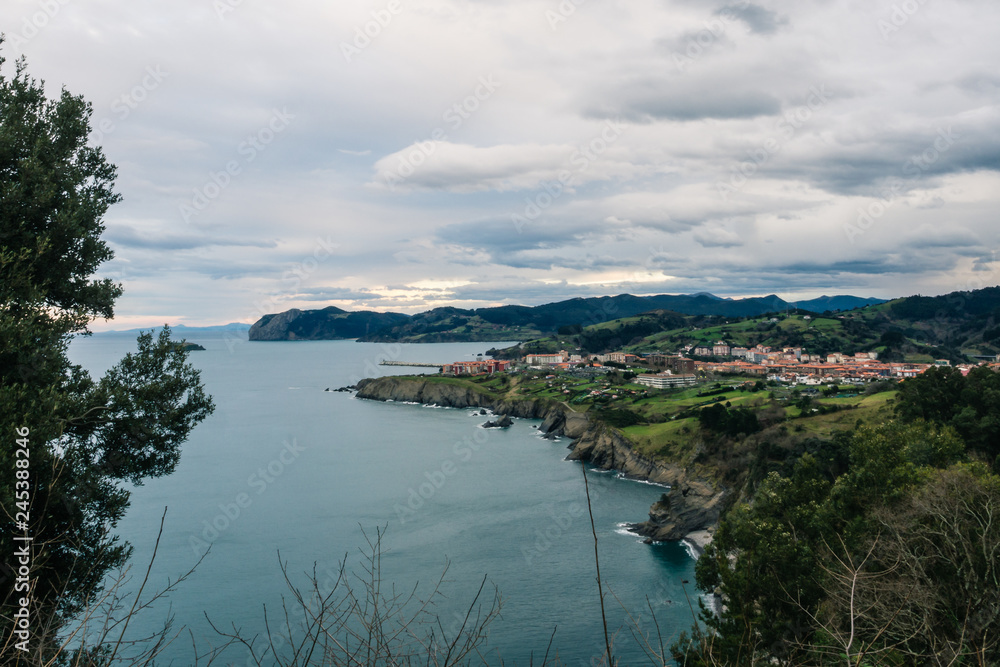 View of the coast of the village of Bermeo on a cloudy day, in the Basque Country View of the coast of the village of Bermeo on a cloudy day, in the Basque Country