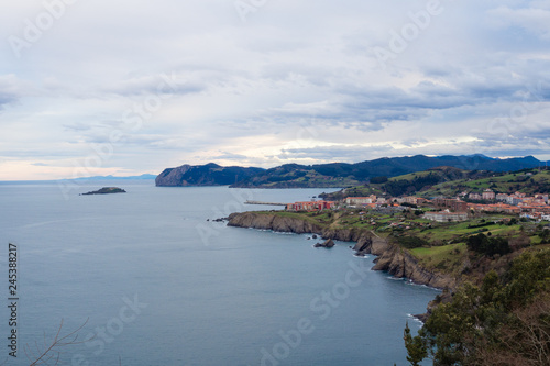 View of the coast of the village of Bermeo on a cloudy day, in the Basque Country