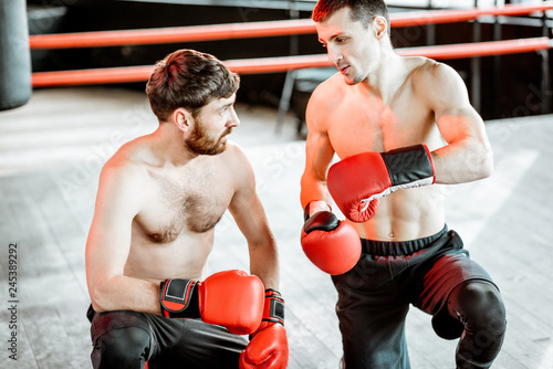 Portrait of a two professional boxers training together on the boxing ring at the gym © rh2010