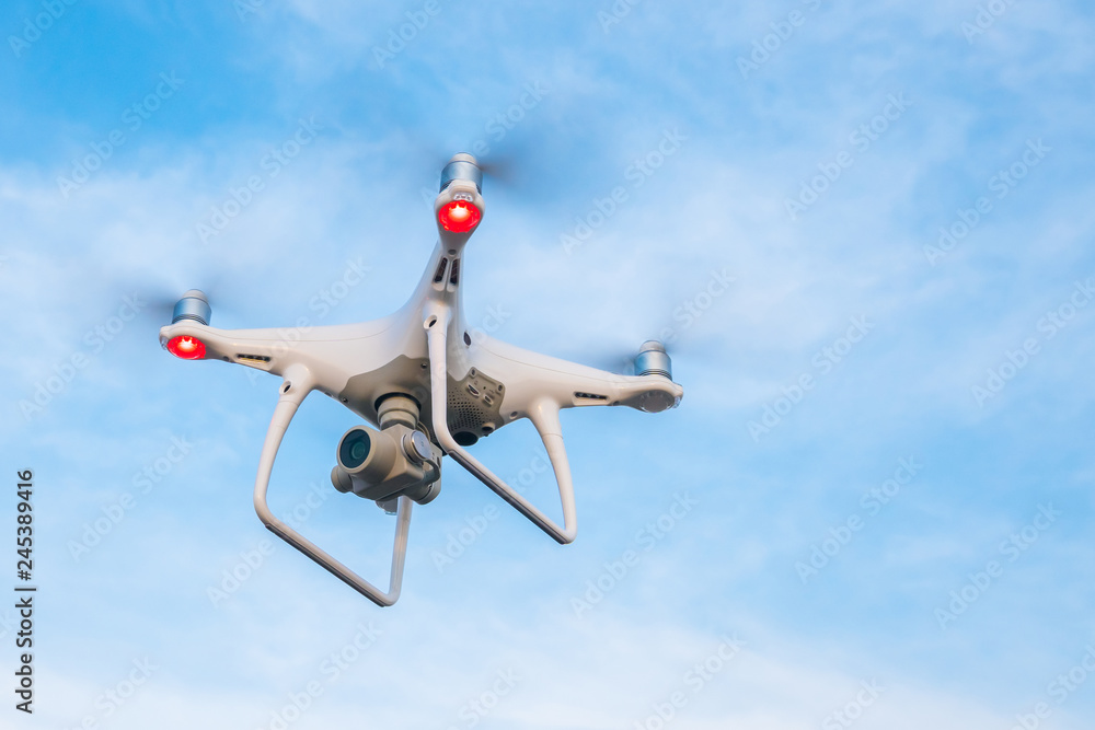 Flying drone with blue sky background Flying drone with blue sky background