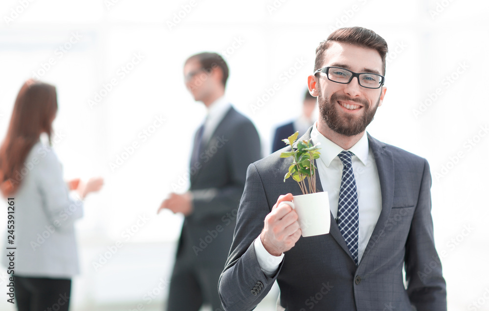 businessman with green young escape on blurred background businessman with green young escape on blurred background