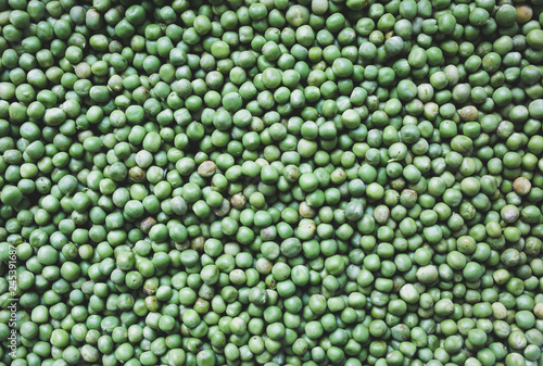 Fresh green peas background. Vegetarian healthy food texture. Vegetables low fat diet. Vertical photo.