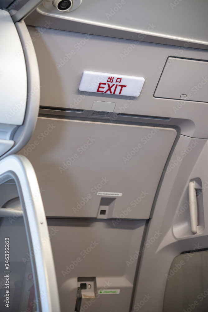 Exit lightbox signage on airplane, escape way of life. way to survive concept Exit lightbox signage on airplane, escape way of life. way to survive concept