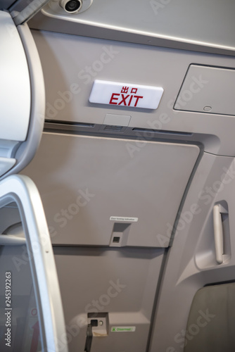 Exit lightbox signage on airplane, escape way of life. way to survive concept