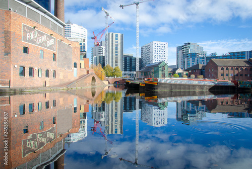 City of Birmingham in Great Britain with a beautiful view on the city wharf with a reflection in the canal water