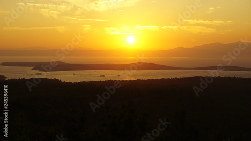 Sunset over sea at Devil s Table    eytan Sofras   . Bright dramatic sky and dark blue ground. Beautiful landscape under scenic colorful orange sky at sunset. Sun over skyline. Warm yellow color concept