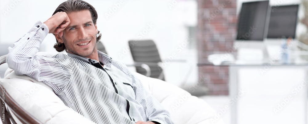 businessman sitting in a chair in the lobby