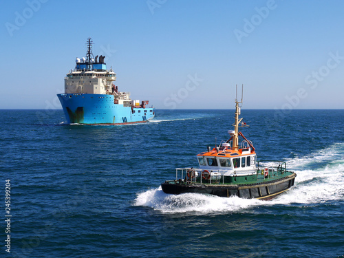 Harbour Pilot Boat underway escorting offshore vessel to harbour.