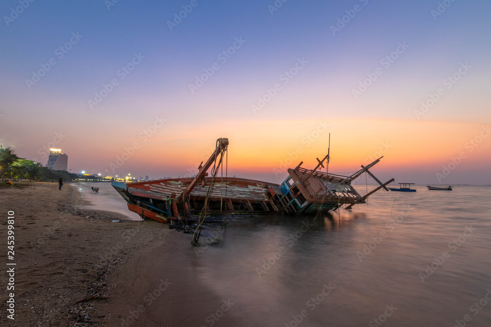 Fishing boat wrecks on the beach Sunset