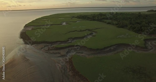Aerial slow move forward of Marajo Island Amazon River inlets and tributaries carved out in the mud landscape at low tide photo