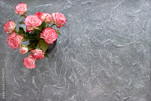 Bunch of pink roses on grey textured background