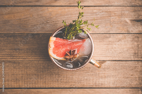 Photography Grapefruit moscow mule in copper mug on the rustic background
