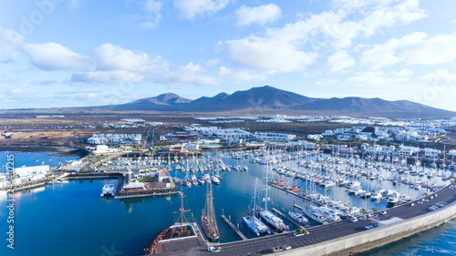 Aerial view of yachts, sail boats, catamarans docked in charming Rubicon marina, Playa Blanca tourist seaside resort,  Lanzarote, Canary Islands, Spain . photo