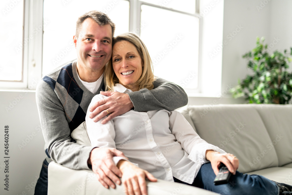 A Mature couple relaxing in couch at home A Mature couple relaxing in couch at home