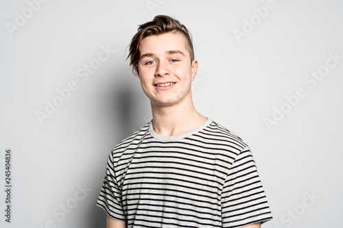 A portrait of young teenager over white wall