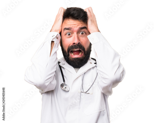 Frustrated young doctor on white background