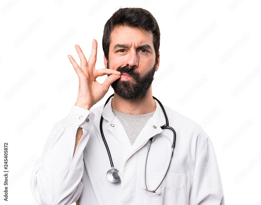 Young doctor making silence gesture on white background Young doctor making silence gesture on white background