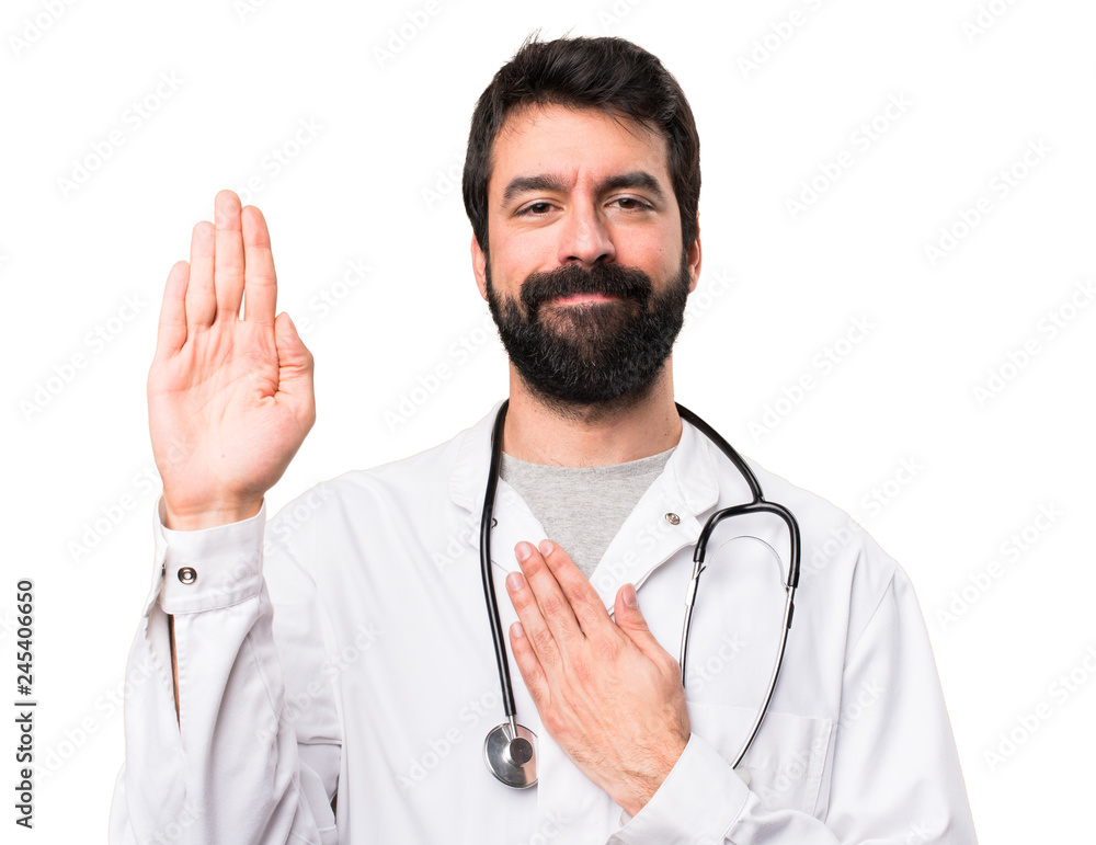 Young doctor making an oath on white background