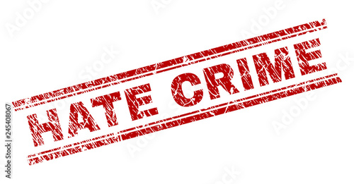 HATE CRIME seal print with distress texture. Red vector rubber print of HATE CRIME caption with dust texture. Text title is placed between double parallel lines.