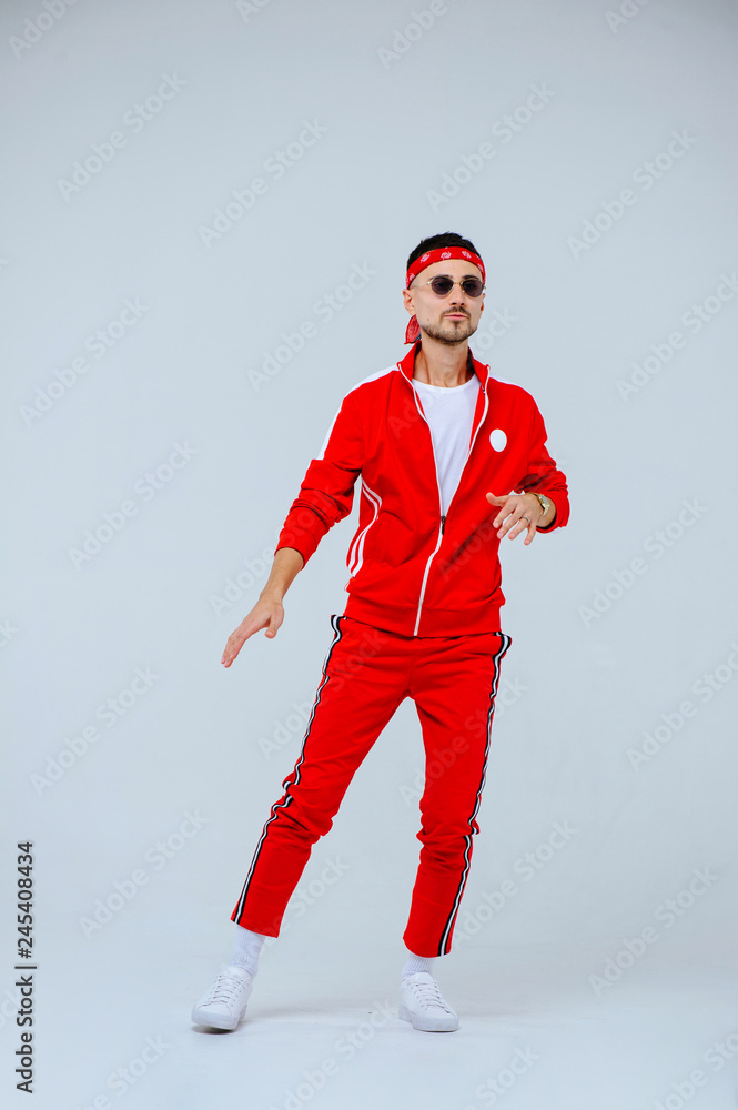health, fun, people sport concept - happy young man wearing red sport suit on white background health, fun, people sport concept - happy young man wearing red sport suit on white background