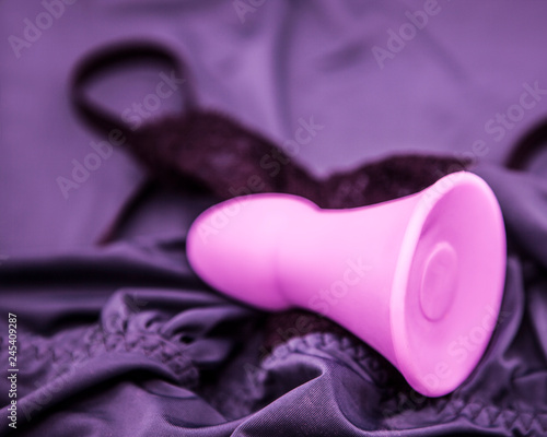 pink anal plug on a purple lace lingerie photo