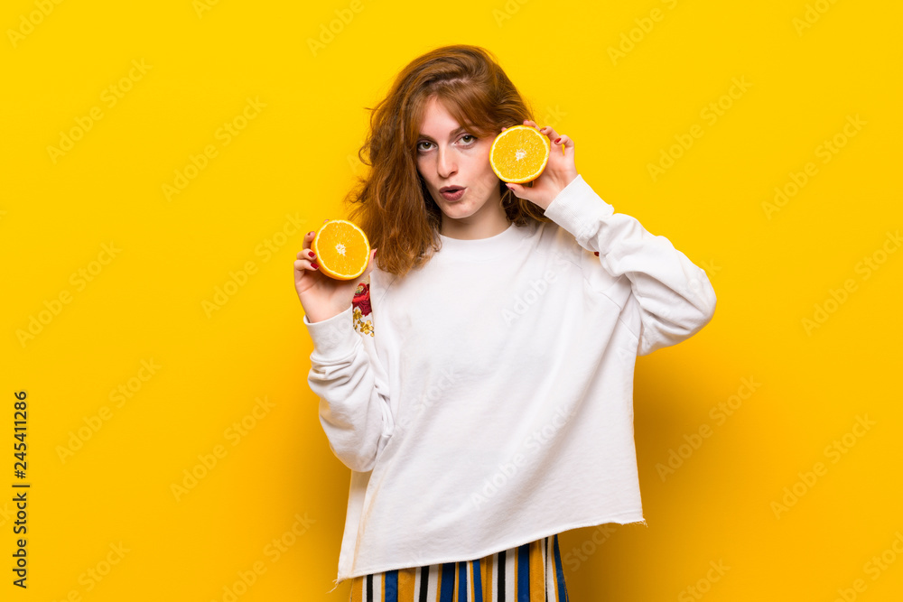 Young redhead woman with orange slices Young redhead woman with orange slices