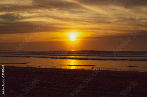 Sunset over main beach in Agadir Morocco showing silhouettes and reflections