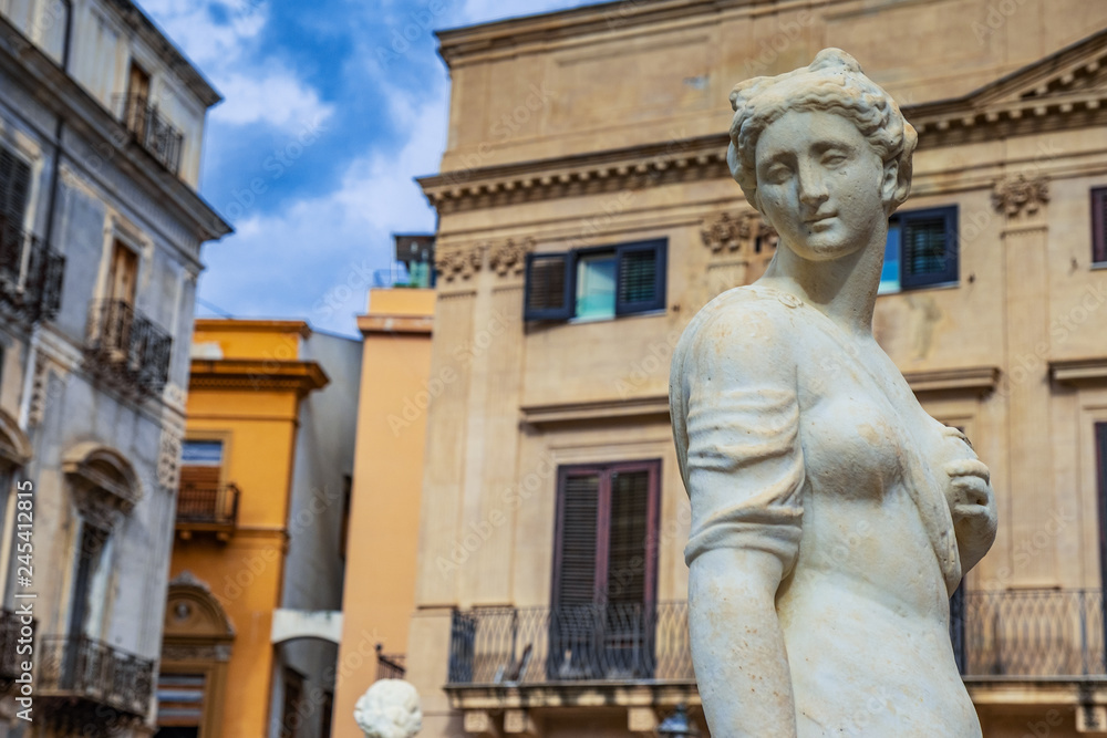 Feminine white stone statue in a Palermo square