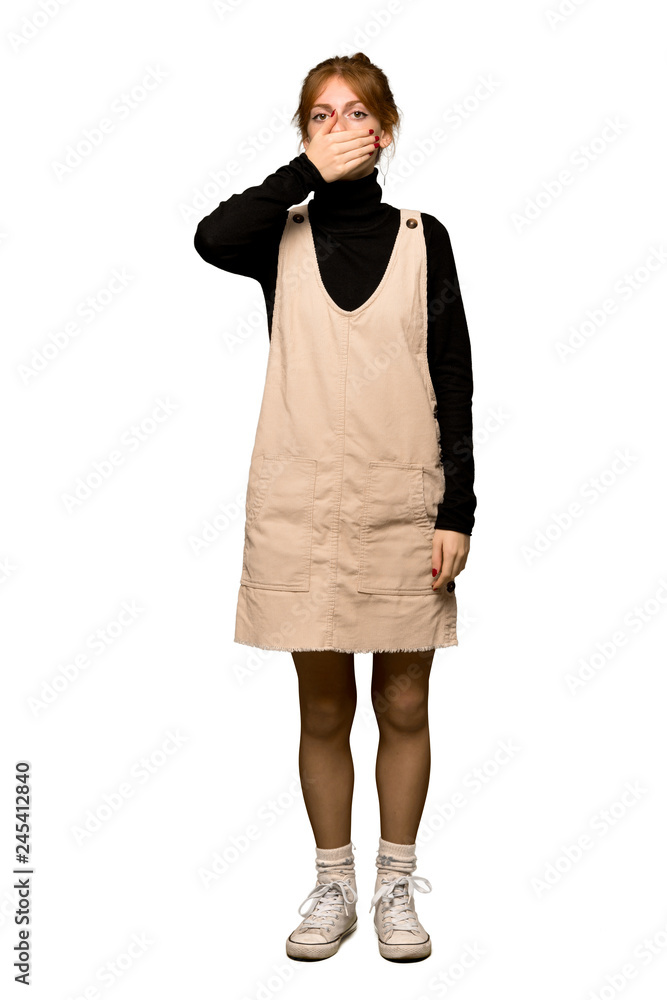 Fototapeta premium A full-length shot of a Young redhead woman covering mouth with hands for saying something inappropriate over isolated white background