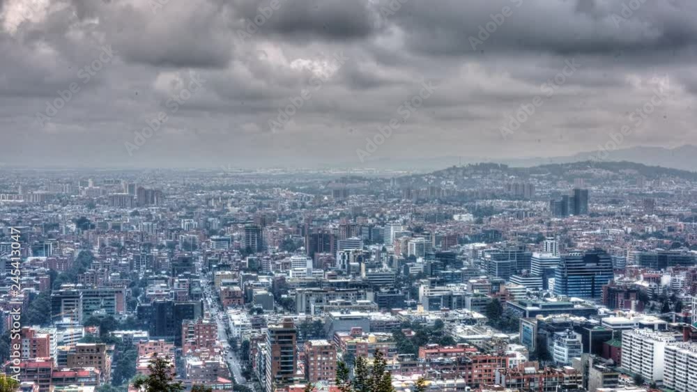 Daytime timelapse of Bogota neighbourhood with sun piercing through ominous sky Daytime timelapse of Bogota neighbourhood with sun piercing through ominous sky