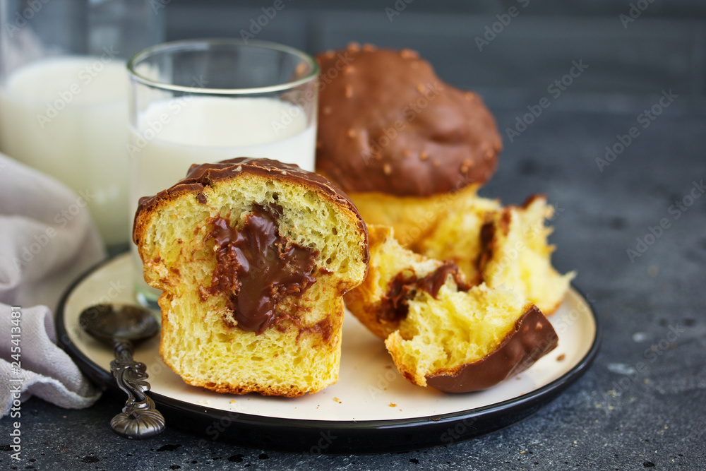 Brioche bun with chocolate filling and chocolate coating. Brioche bun with chocolate filling and chocolate coating.