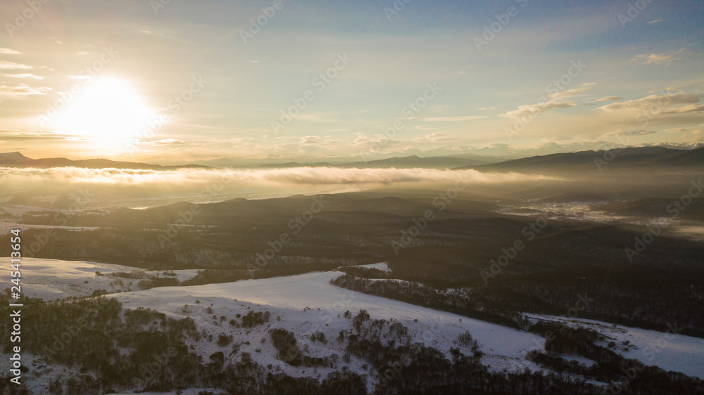 Sunset in the winter mountains landscape. Aerial view from above.