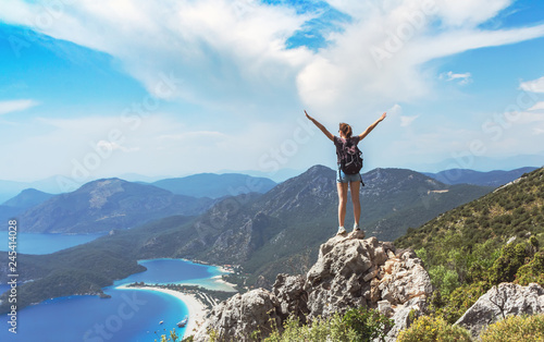 Hiker girl on the mountain top    oncept of freedom  victory  active lifestyle  Oludeniz  Turkey