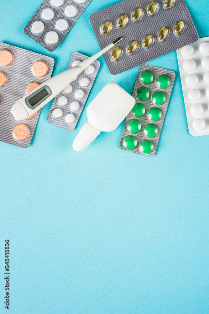 Tablets and medicines on a blue background. Tablets and medicines on a blue background.