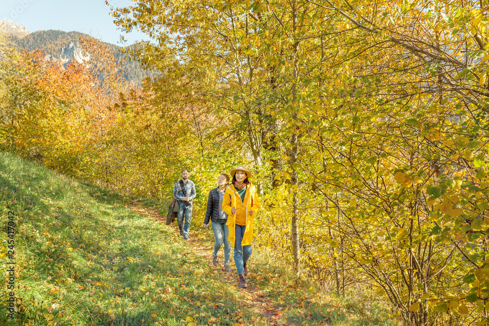 Happy asian woman hiking in autumn forest